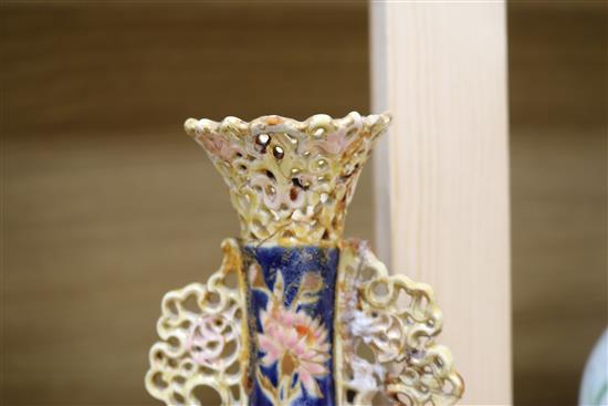 A pair of Zsolnay Pecs reticulated vases, floral-decorated on a blue ground and heightened in gilt height 20cm (a.f.)